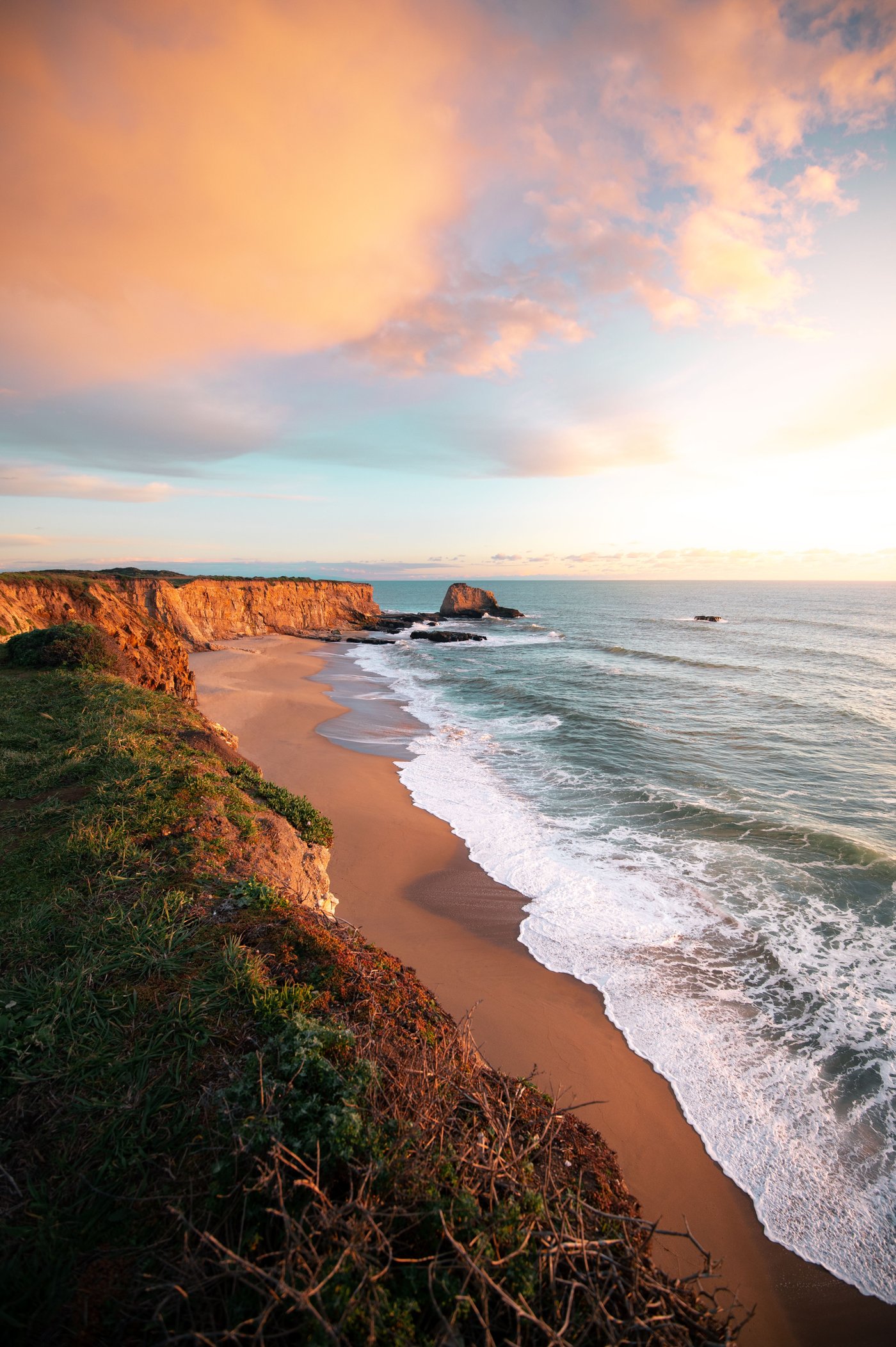 Santa Cruz coastline at sunset — cliffs, beach, and Pacific surf