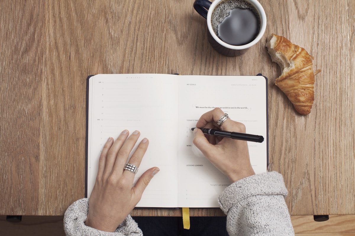 Notebook and pen on a sunlit desk